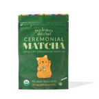 Green package of ceremonial matcha with a cat illustration on a white background